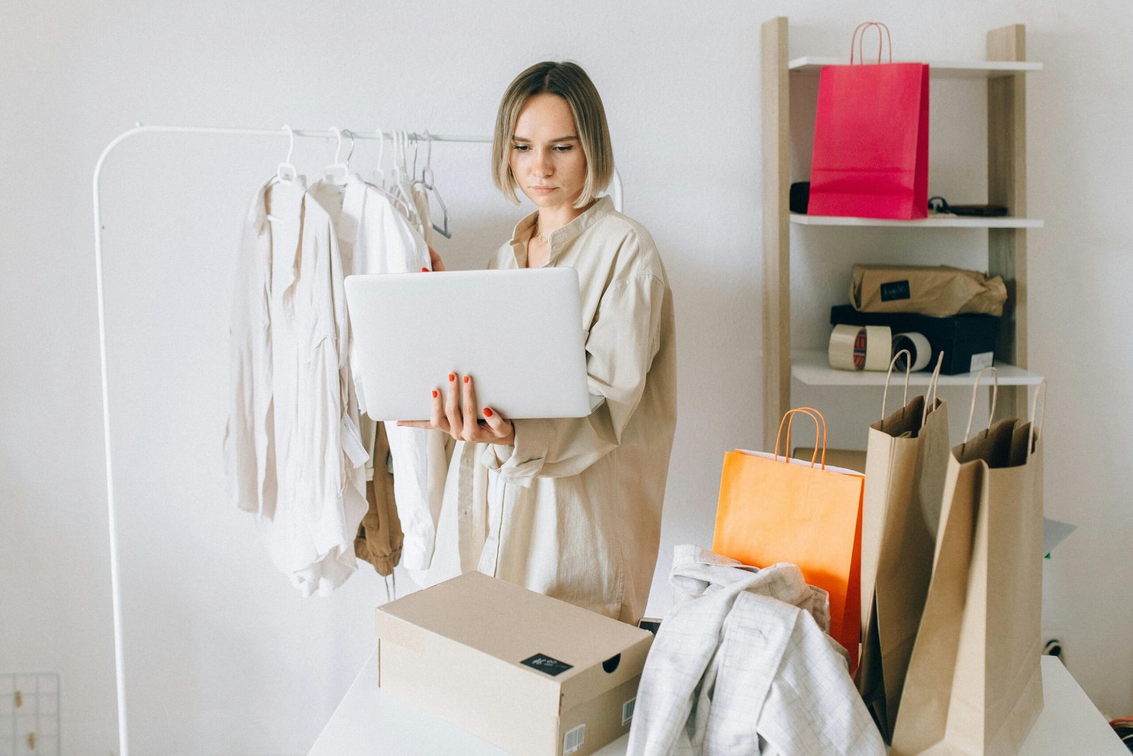 woman-in-beige-long-sleeve-shirt-holding-a-laptop- pump it up magazine -